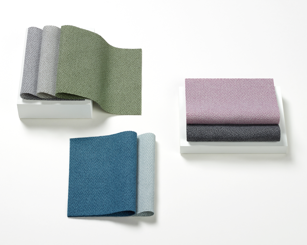 An image of Mellow fabric swatches on a white surface. Colors are cool and include blues, purples, greens, and greys.