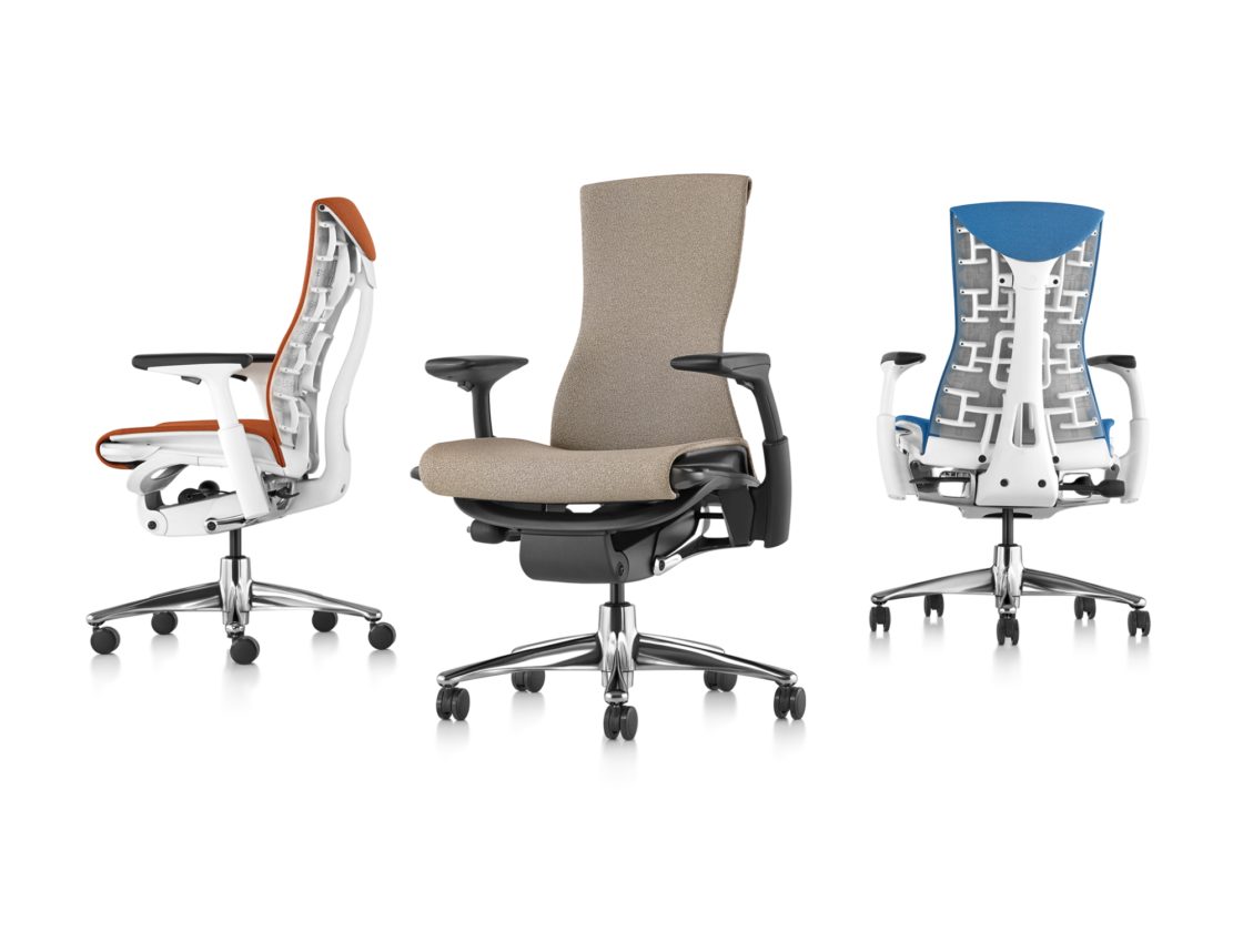 Three Embody chairs with different finishes facing sideways, forwards, and backwards to show off the ergonomic design.