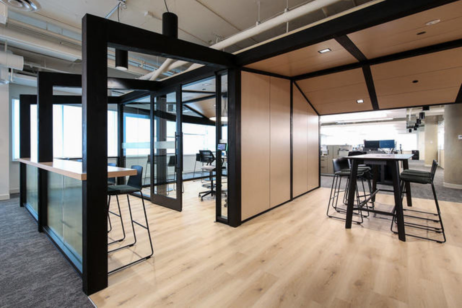 The interior of an office with wood, metal, and glass interior partitions.