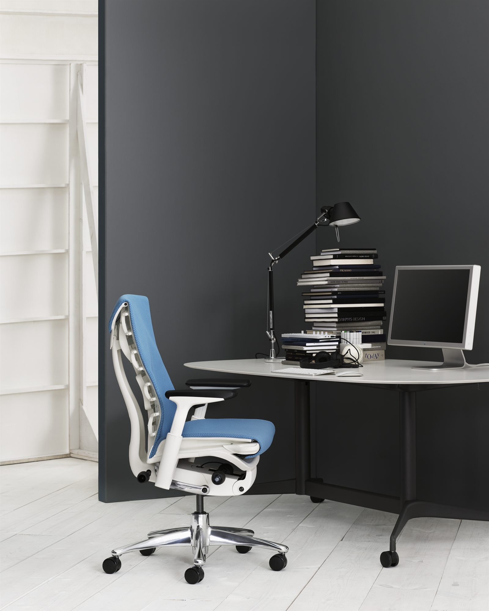 An image of a home office with a blue Embody chair.