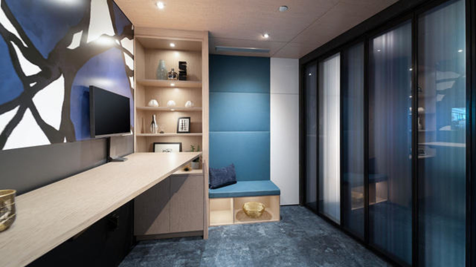 A hallway lined with DIRTT glass and metal walls and doorts.