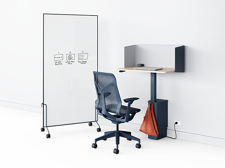 A navy OE1 Micro Pack plugged into a wall in front of a navy Cosm task chair with a OE1 Mobile Whiteboard next to it to create a private workspace.
