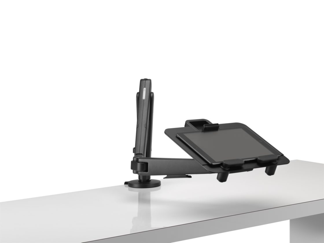 A black Ollin Laptop and Tablet Mount holding a tablet pulled forward to reduce eye strain mounted on a black Ollin Monitor Arm.